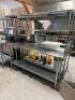 DESCRIPTION 72" X 24" STAINLESS TABLE W/ TWO TIER RISER SHELF. ADDITIONAL INFORMATION W/ TICKET RAIL SIZE 72" X 24" LOCATION KITCHEN QTY 1 - 2