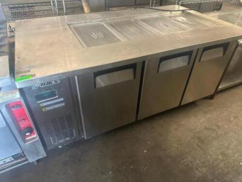 DESCRIPTION TORRISON THREE DOOR OPEN TOP PREP TABLE. BRAND / MODEL: TORRISON ADDITIONAL INFORMATION 115 VOLT, 1 PHASE. TESTED AND COOLING. LOCATION BA
