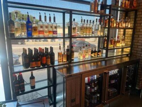 DESCRIPTION 9' THREE-SECTION CUSTOM METAL RACK WITH GLASS INSERT SHELVING, DESIGNED FOR BACK BAR BOTTLE DISPLAY. BUILT TO FIT AN 84" BACK BAR COOLER O