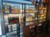 DESCRIPTION 9' THREE-SECTION CUSTOM METAL RACK WITH GLASS INSERT SHELVING, DESIGNED FOR BACK BAR BOTTLE DISPLAY. BUILT TO FIT AN 84" BACK BAR COOLER O