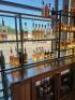 DESCRIPTION 9' THREE-SECTION CUSTOM METAL RACK WITH GLASS INSERT SHELVING, DESIGNED FOR BACK BAR BOTTLE DISPLAY. BUILT TO FIT AN 84" BACK BAR COOLER O - 3