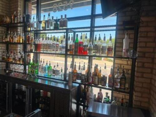 DESCRIPTION 9' THREE-SECTION CUSTOM METAL RACK WITH GLASS INSERT SHELVING, DESIGNED FOR BACK BAR BOTTLE DISPLAY. BUILT TO FIT AN 84" BACK BAR COOLER O
