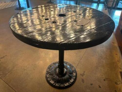 DESCRIPTION 44" ROUND PUB TABLE BUILT FROM WOODEN CABLE SPOOL WITH CAST IRON BASE ADDITIONAL INFORMATION RUSTIC PUB TABLE CRAFTED FROM A REPURPOSED WO