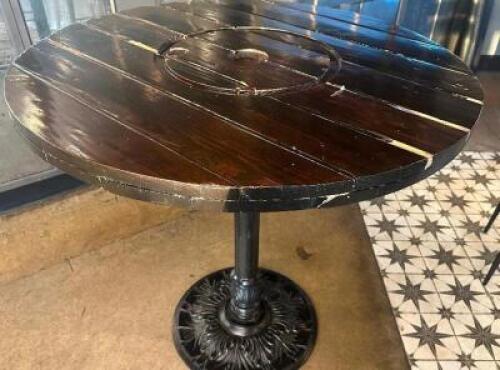 DESCRIPTION 44" ROUND PUB TABLE BUILT FROM WOODEN CABLE SPOOL WITH CAST IRON BASE ADDITIONAL INFORMATION RUSTIC PUB TABLE CRAFTED FROM A REPURPOSED WO