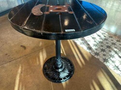 DESCRIPTION 44" ROUND PUB TABLE BUILT FROM WOODEN CABLE SPOOL WITH CAST IRON BASE ADDITIONAL INFORMATION RUSTIC PUB TABLE CRAFTED FROM A REPURPOSED WO
