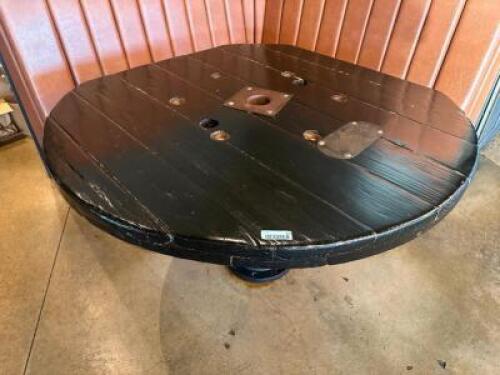 DESCRIPTION CUSTOM TABLE WOODEN (APPROX. 52" X 52" ADDITIONAL INFORMATION MADE FROM A REPURPOSED CABLE SPOOL WITH A HEAVY CAST IRON BASE. INDUSTRIAL A