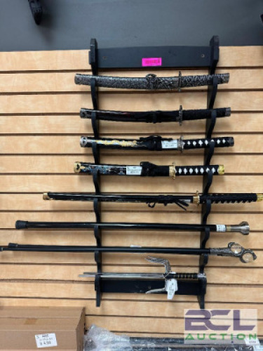 DESCRIPTION (10) ASSORTED NOVELTY KATANAS AND SAMURI SWORDS ADDITIONAL INFORMATION (3) WOODED WALL RACKS INCLUDED IN LOT. MOST KNIVES RETAIL FOR $25 T