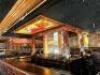 22' X 18' VINTAGE HARDWOOD BAR WITH RICH PANEL DETAILING IMPRESSIVE U-SHAPED BAR CONSTRUCTED OF SOLID HARDWOOD WITH DEEP, DARK FINISH AND ELEGANTLY CRAFTED PANELING. FEATURES A STAINED GLASS CEILING INSET ABOVE, MULTIPLE SERVICE STATIONS, AND AMPLE COUNTE - 5
