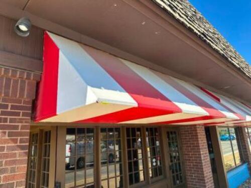 12' ALUMINUM FRAME AWNING IN RED AND WHITE STIPE VINYL WITH INTERNAL BACK LIGHTING.