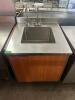 STAINLESS COUNTER TOP WITH SINK AND WATER DISPENSER.