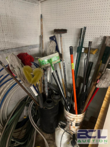 CONTENTS OF CORNER - LARGE ASSORTMENT OF LONG HAND CLEANING AND GARDENING TOOLS.