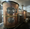 BOHEMIAN-STYLE COPPER-CLAD BREWHOUSE SYSTEM FEATURING MASH/LAUTER TUN, BOIL KETTLE, AND HOT LIQUOR TANK. INCLUDES STAINLESS VALVE MANIFOLD, PLATE HEAT EXCHANGER, AND CONTROL PANELS.