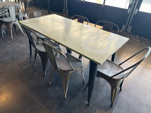 63" X 3 0" COMPOSITE TOP PATIO TABLE W/ (6) METAL STACK CHAIRS.