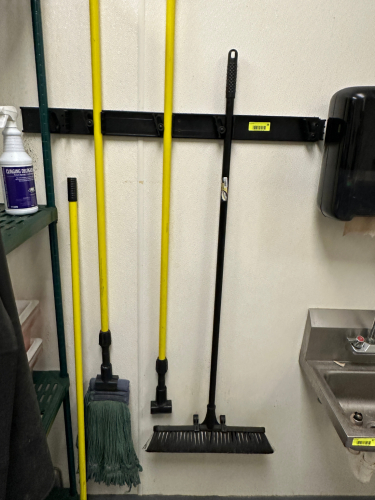 (2) WALL MOUNTED TOOL HOLDER W/ CONTENTS - ASSORTED LONG HANDLE CLEANING SUPPLIES.