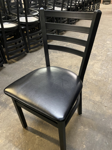 (8) BLACK METAL LADDER BACK CHAIRS W/ BLACK PADDED SEATS.