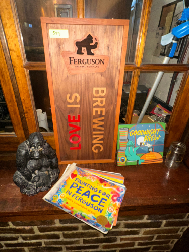 FERGUSON BREWING COMPANY SIGN, STATUE, AND ASSORTED BOOKS.
