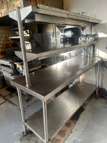 60" X 24" STAINLESS TABLE W/ TWO TIER STAINLESS RISER W/ (1) HEAT LAMP.