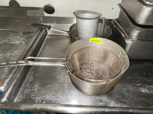 (2) SAUCE POTS, (1) MEASURING CUP, AND (1) MESH STRAINER.