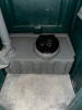 STANDARD PORTABLE RESTROOM / PORTA-POTTY WITH DURABLE MOLDED PLASTIC CONSTRUCTION DESIGNED FOR JOB SITES AND EVENTS. FEATURES INCLUDE VENTED ROOF, SECURE LOCKING DOOR, AND COMPACT FOOTPRINT FOR EASY PLACEMENT AND TRANSPORT. UNIT SHOWS NORMAL COSMETIC WEAR - 4