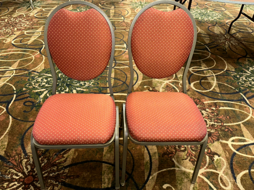 (20) MAROON AND TAN UPHOLSTERED STACK CHAIRS W/ METAL FRAME.