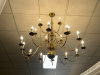 MULTI-ARM BRASS CHANDELIER WITH CANDLE-STYLE LIGHT SOCKETS AND POLISHED METAL FINISH. TRADITIONAL DESIGN WITH CURVED ARMS AND CENTRAL BALL ACCENT.