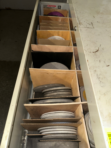 LATERAL FILE CABINET AND CONTENTS - LARGE ASSORTMENT OF STONE GRINDING WHEELS AND PADS.