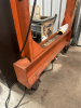 MOBILE STEEL GANTRY CRANE EQUIPPED WITH COFFING 5-TON ELECTRIC CHAIN HOIST AND HEAVY-DUTY STEEL I-BEAM. FEATURES RIGID WELDED FRAME, ROLLING CASTERS FOR SHOP MOBILITY, AND INTEGRATED POWERED HOIST WITH HOOK AND CHAIN AS SHOWN. - 5
