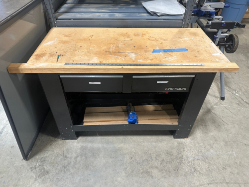 CRAFTSMAN FABRICATION TABLE W/ WOODEN TOP AND METAL BASE.