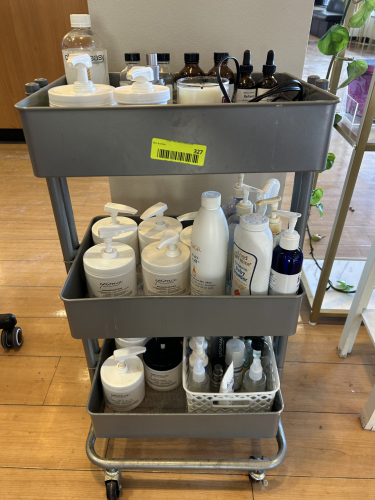 THREE-TIER METAL ROLLING UTILITY CART WITH OPENED ESTHETICIAN PRODUCTS