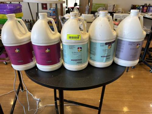 LOT OF PUREOLOGY SALON USE SHAMPOO AND CONDITIONER GALLON BOTTLES. INCLUDES SMOOTH PERFECTION, STRENGTH CURE, AND HYDRATE FORMULAS. ONE GALLON EACH AS SHOWN. PARTIAL CONTENT LEVELS