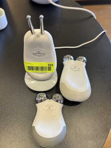 NUFACE PRO FACIAL TONING DEVICES WITH CHARGING BASE AND ATTACHMENTS. INCLUDES THREE HANDHELD UNITS