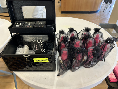 COSMETIC STORAGE CASE WITH ASSORTED MAKEUP ITEMS AND MULTIPLE GIFT BAGS CONTAINING SPRAY BOTTLES AND ACCESSORIES