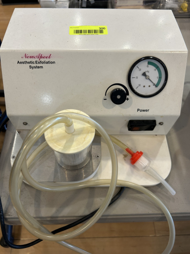 NEWSPEEL AESTHETIC EXFOLIATION SYSTEM WITH VACUUM GAUGE, ADJUSTABLE SUCTION CONTROL, AND ATTACHED TUBING. POWERED UNIT.