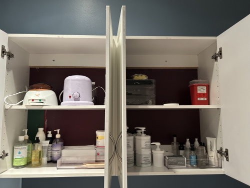 USED AESTHETICIAN FACIAL PRODUCTS, WAXING MACHINES AND PRODUCTS. CONTENTS OF TWO UPPER CABINETS AND TWO LOWER DRAWERS