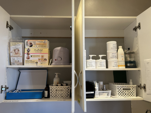 USED AESTHETICIAN FACIAL PRODUCTS, WAXING MACHINES AND PRODUCTS. CONTENTS OF TWO UPPER CABINETS AND LOWER DRAWER AND COUNTER