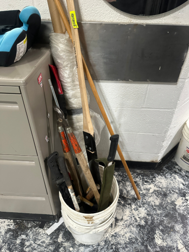 BUCKET AND CONTENTS - ASSORTED PRUNING TOOLS , BLADES, AND LOPPERS.