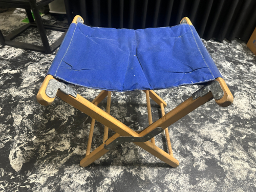 (40) SMALL FOLDING CANVAS STOOLS W/ BLACK ROLL ABOUT STORAGE CRATE.