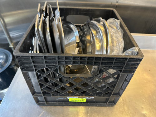 MILK CRATE AND CONTENTS - ASSORTED STAINLESS LIDS.