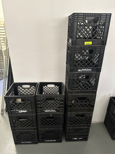 (12) BLACK PLASTIC MILK CRATES.
