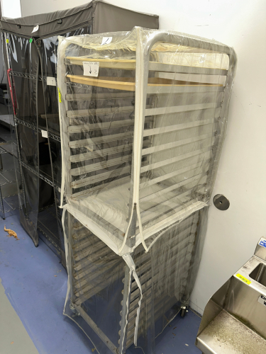 TWENTY PAN TRAY RACK W/ PLASTIC COVER.