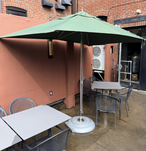 6' X 8' GREEN CANVAS PATIO UMBRELLA WITH TUUCI BASE.