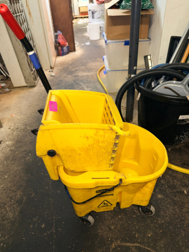(2) YELLOW MOP BUCKETS W/ WRINGERS.