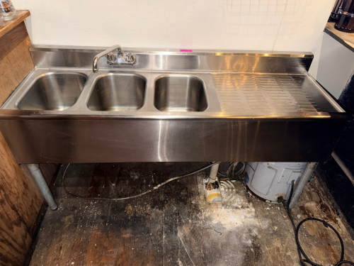 50" THREE WELL STAINLESS UNDER BAR SINK W/ RIGHT SIDE DRY BOARD.