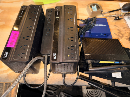 (2) BATTERY BACK UPS AND ASSORTED ROUTER AND MODEMS