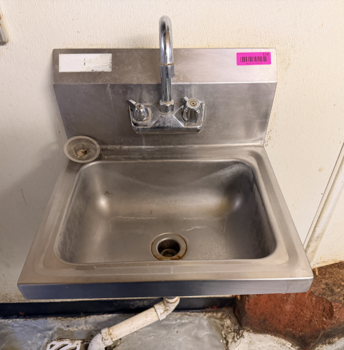 WALL MOUNTED STAINLESS HAND SINK.