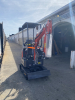COMPACT TRACK MINI EXCAVATOR WITH OPEN CANOPY, RUBBER TRACKS, AND FRONT DOZER BLADE. EQUIPPED WITH HYDRAULIC BOOM, BUCKET, AND PILOT JOYSTICK CONTROLS. IDEAL FOR LIGHT CONSTRUCTION, LANDSCAPING, AND TRENCHING APPLICATIONS. - 7