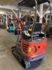 COMPACT TRACK MINI EXCAVATOR WITH OPEN CAB, RUBBER TRACKS, AND FRONT BLADE. HYDRAULIC BOOM WITH BUCKET ATTACHMENT AND CONTROL LEVER OPERATION. UNIT FEATURES PROTECTIVE CANOPY, REAR ENGINE COMPARTMENT, AND COMPACT BODY DESIGN.