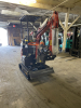 COMPACT TRACK MINI EXCAVATOR WITH OPEN CAB, RUBBER TRACKS, AND FRONT BLADE. HYDRAULIC BOOM WITH BUCKET ATTACHMENT AND CONTROL LEVER OPERATION. UNIT FEATURES PROTECTIVE CANOPY, REAR ENGINE COMPARTMENT, AND COMPACT BODY DESIGN. - 7