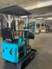 COMPACT TRACK MINI EXCAVATOR WITH OPEN CAB, RUBBER TRACKS, AND FRONT BLADE. HYDRAULIC BOOM WITH BUCKET ATTACHMENT AND CONTROL LEVER OPERATION. UNIT FEATURES PROTECTIVE CANOPY, REAR ENGINE COMPARTMENT, AND COMPACT BODY DESIGN. - 6