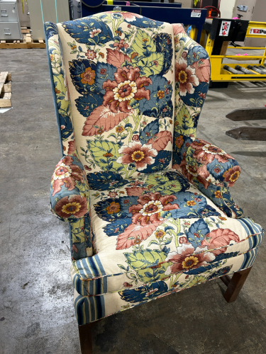 VINTAGE MAHOGANY WING CHAIR FEATURING A FLORAL PRINTED FABRIC